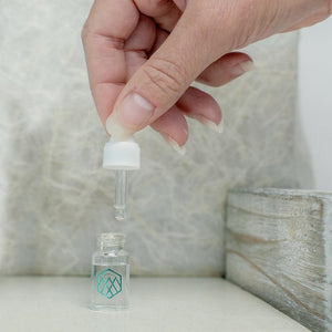 woman holding a LumenKind water dropper.