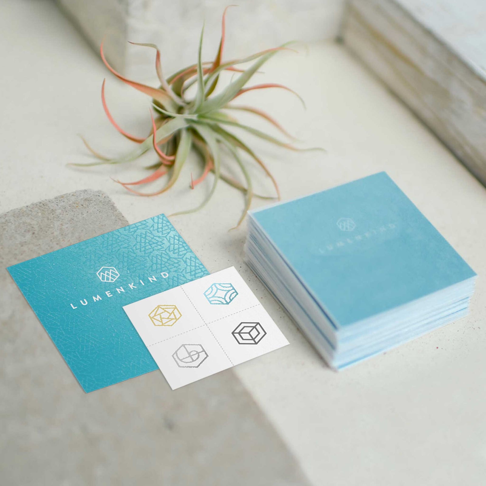 A stack of LumenKind Minis mindful marks temporary mindfulness tattoo wearable reminders sitting on a table.