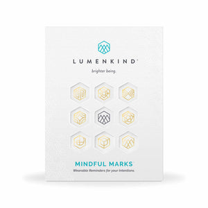 The front side of a pack of Mindful Marks —Balance Collection (Gold), wearable reminders for your intentions.
