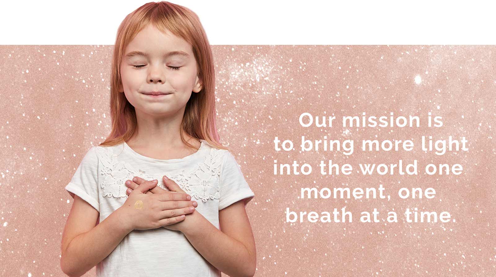Little girl with eyes closed, both hands at her heart, taking a deep breath. Her mission is to bring more light into the world.