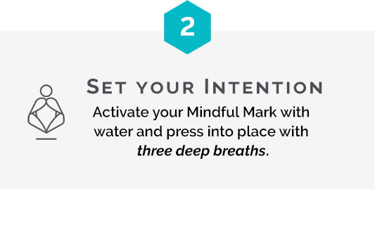 Step two is setting your intention by activating a temporary tattoo with water and pressing it into place with three breaths