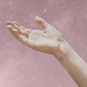 hand with palm up to sky wearing Attract Mindful Mark, a temporary tattoo for mindfulness