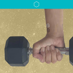 woman holding dumbbell weight wearing three strength mindful mars on her wrist.