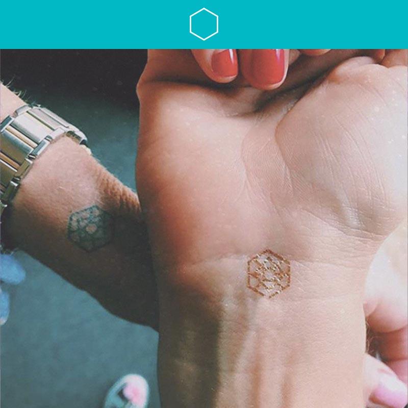 Therapist Krista Kilbane's wrist with a gold mindful mark that represents visualize.