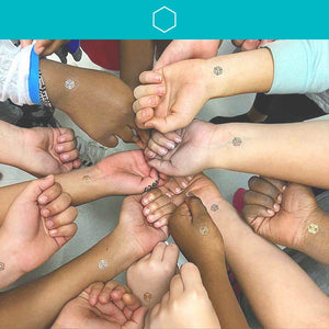 A diverse group of about a dozen people wearing mindful marks on their wrists and hands, fist bumping in a circle pattern.
