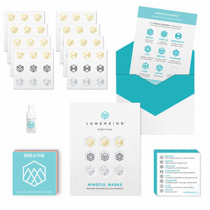 Layout of what comes with a LumenKind Balance Kit, including 72 total marks divided by color and design, choose deck, invitation to mindfulness, and a water dropper.