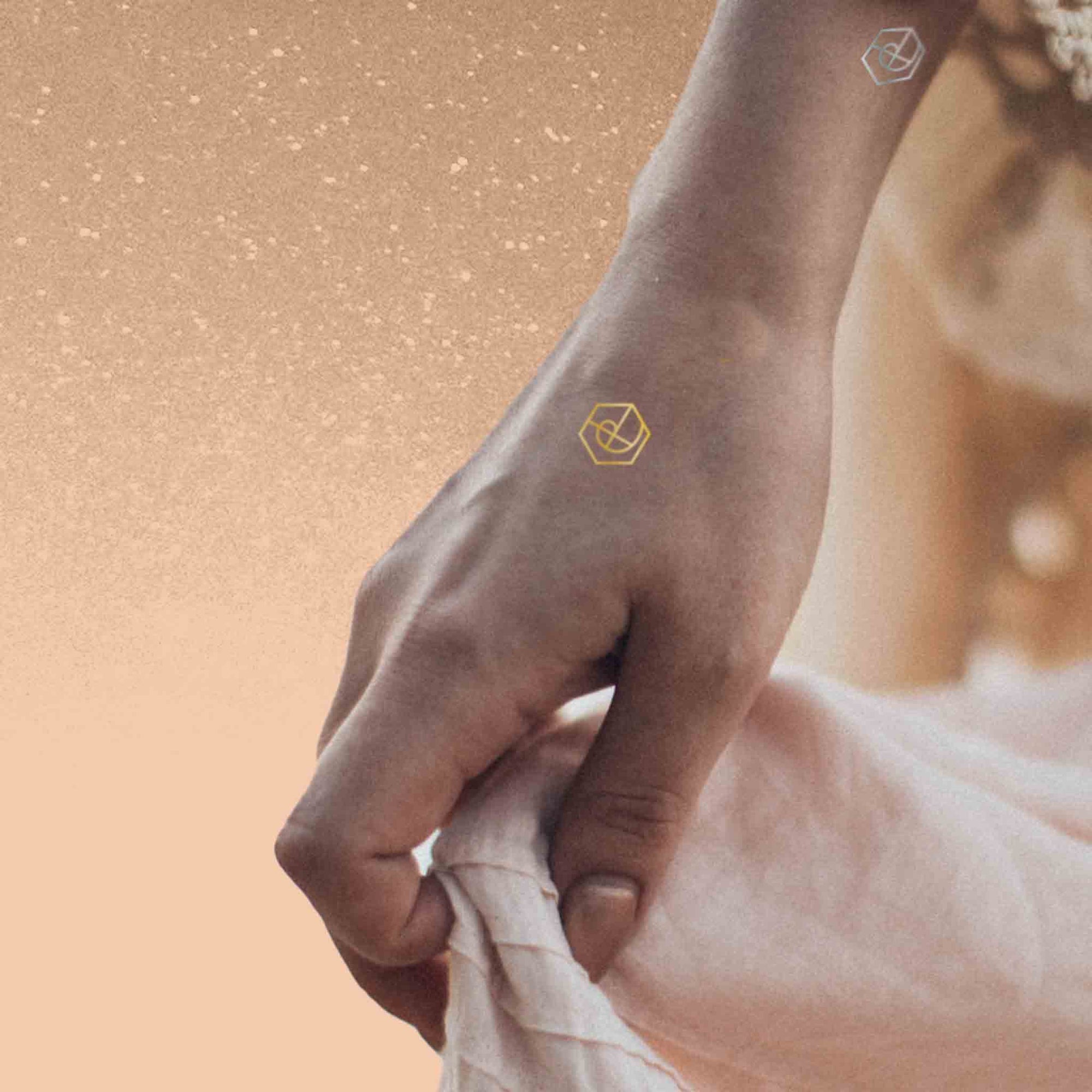 Woman holding her dress while wearing multiple Mindful Marks temporary mindfulness tattoo wearable reminders.